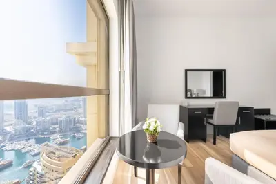 a living room with a table in front of a window at Luxe Marina View Retreat! 2BDRM in Dubai
