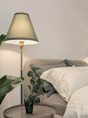 a lamp on a table next to a bed at Stylish Urban-Jungle-Studio in Al Barari, Dubai in Dubai
