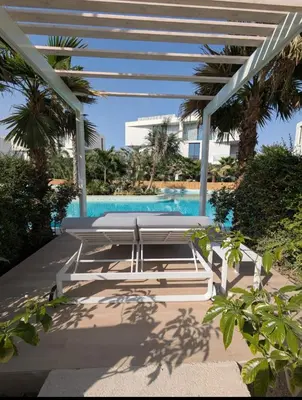 a view of a swimming pool with trees and a building at Stylish Urban-Jungle-Studio in Al Barari, Dubai in Dubai