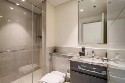 a bathroom with a shower and a sink and a mirror at KING 2BR LUX Apt-5mins Dubai Mall-Downtown Dubai in Dubai