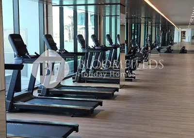 a row of cardio machines in a gym at Bloomfields Amber Horizon Stu Binghatti in Dubai