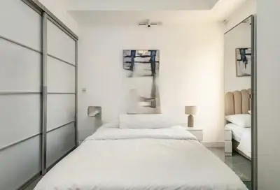a bedroom with two beds and a mirror at Ahlan Furnished Full Apartment Marina Cityview JBR Beach for Families in Dubai