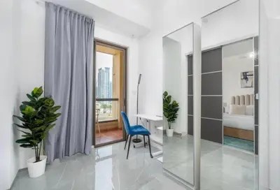 a white bathroom with a blue chair and a desk at Ahlan Furnished Full Apartment Marina Cityview JBR Beach for Families in Dubai