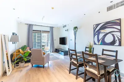 a living room with a dining room table and chairs at 2BR Breathtaking Waterfront Heart of Marina in Dubai