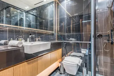 a bathroom with a white toilet and a sink at Skyline-View 1BR with Balcony,Minutes to Downtown and Marina, Binghatti Onyx, Jumeirah Village Circle by Deluxe Holiday Homes in Dubai