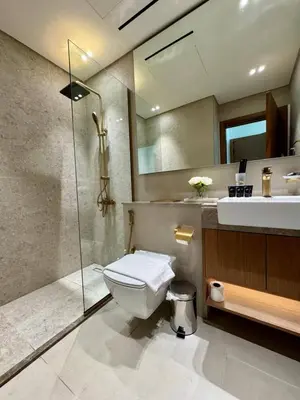 a bathroom with a toilet and a shower and a sink at Chic Jvc 1br Pool Access, Balcony & Parking in Dubai