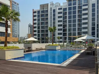 a swimming pool in a building with tall buildings at Frank Porter - Azizi Riviera 16 in Dubai