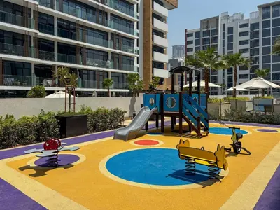 a playground with a slide and a slideintend at Frank Porter - Azizi Riviera 16 in Dubai