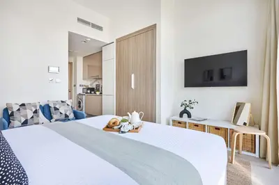 a bedroom with a bed with a tv on the wall at Frank Porter - Azizi Riviera 16 in Dubai
