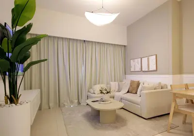 a living room with a couch and a table at Modern 1BR in Downtown Near Burj Khalifa & Metro in Dubai