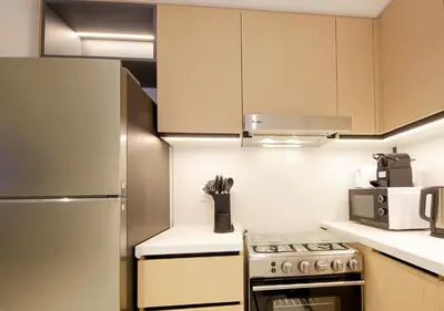 a kitchen with a stove and a refrigerator at Modern 1BR in Downtown Near Burj Khalifa & Metro in Dubai