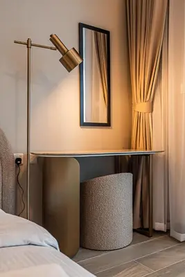 a bedroom with a desk with a mirror and a bed at Elegant 1BDR apartment in JVC in Dubai