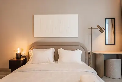 a bedroom with a bed with white pillows at Elegant 1BDR apartment in JVC in Dubai