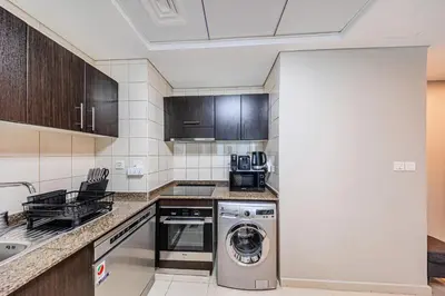 a kitchen with a washer and a dishwasher at 1 BD in Bay Central with the Iconic Marina Views in Dubai