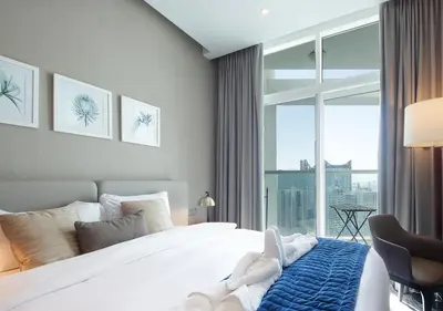 a bedroom with a bed and a large window at Luxury Damac Studio w Canal View Near Burj Khalifa in Dubai