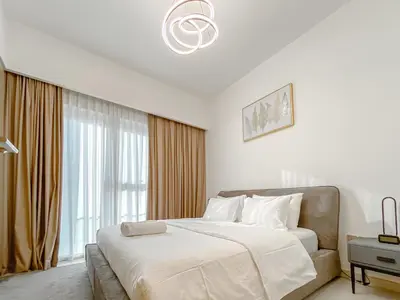 a white bedroom with a large bed and a window at Majestic Burj Khalifa View 2BR Premium Apartment By SBH in Dubai
