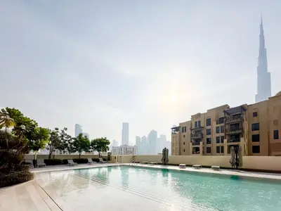 a swimming pool with a city skyline in the background at Majestic Burj Khalifa View 2BR Premium Apartment By SBH in Dubai