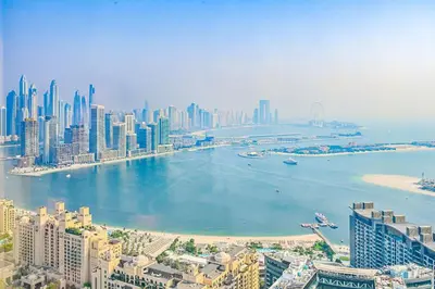 an aerial view of a city with a body of water at Exquisite studio - Highest at the Palm Tower in Dubai