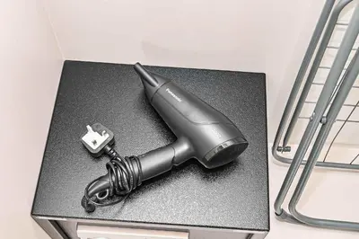 a hairdryer sitting on top of a table at Exquisite studio - Highest at the Palm Tower in Dubai