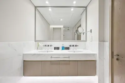 a bathroom with a sink and a mirror at Exquisite studio - Highest at the Palm Tower in Dubai