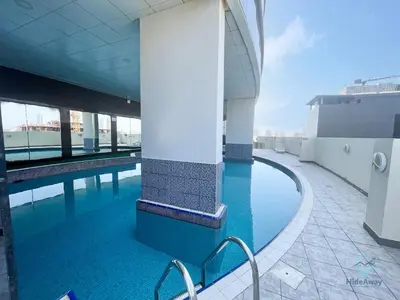a swimming pool with blue water in a building at Bright Modern 1BR Heart Of JLT Skyline Views in Dubai