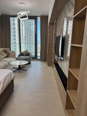 a living room with a couch and a tv at New luxury Studio at Prestigious Liv Residence in Dubai