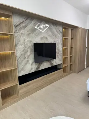 a living room with a fireplace with a tv at New luxury Studio at Prestigious Liv Residence in Dubai
