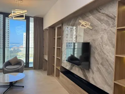 a living room with a tv on a wall at New luxury Studio at Prestigious Liv Residence in Dubai
