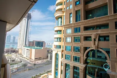 a tall building with a view of a city at 1BR Charming Modern 5Min to Beach Dubai Marina in Dubai