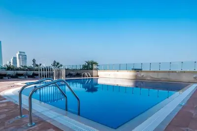 a large swimming pool with aicrobialicrobialicrobialicrobialicrobial at 1BR Charming Modern 5Min to Beach Dubai Marina in Dubai