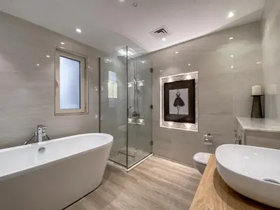 a bathroom with a tub and a glass shower at Live the Burj Lifestyle in Timeless OldTown by SBH in Dubai