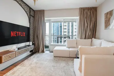 a living room with a white couch and a television at Arabian Nights 1BR - Burj Khalifa & Fountain Views - 5 Mints Walk to Burj Khalifa and Dubai Mall in Dubai