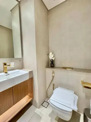 a bathroom with a sink and a toilet and a mirror at Tranquil 1br Retreat Stylish Stay In Jvc in Dubai