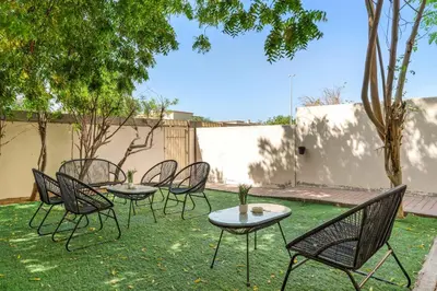 a group of chairs and tables in a yard at Silkhaus Luxe 2 BDR with Maid room in Springs 7 Villa 14 in Dubai