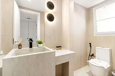 a bathroom with a tub and a toilet and a window at Silkhaus Luxe 2 BDR with Maid room in Springs 7 Villa 14 in Dubai