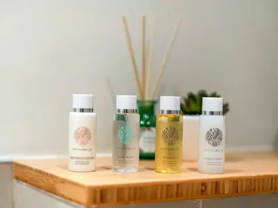 a group of four products sitting on a wooden shelf at Wonderful Stay at Collective 2- Unique in Dubai Hills - 5 min to Dubai Hills Mall - Brand New Luxury Apartments in Dubai