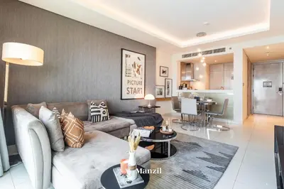 a living room with a couch and a table at Premium 2BR Apartment in Paramount Tower with City Skyline Views in Dubai