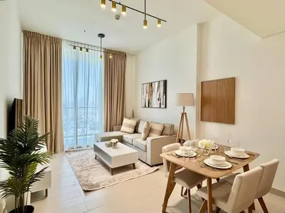 a living room with a table and a couch at Modern 1br W Calm Interiors Jvc Dubai in Dubai