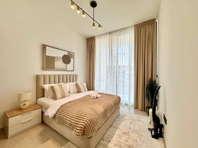 a bedroom with a bed and a large window at Modern 1br W Calm Interiors Jvc Dubai in Dubai