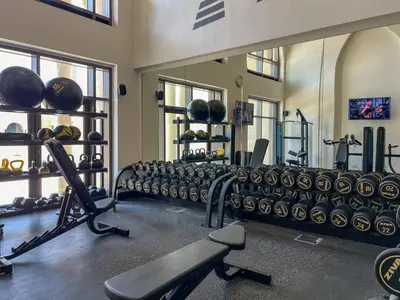 a gym with a bunch of equipment in a room at Durrani Homes - Luxe Living at Souk Al Bahar with Burj Khalifa and partial Fountain view in Dubai