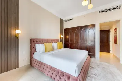 a bedroom with a large bed in a room at Durrani Homes - Luxe Living at Souk Al Bahar with Burj Khalifa and partial Fountain view in Dubai