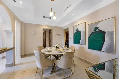 a dining room with a table and chairs at Durrani Homes - Luxe Living at Souk Al Bahar with Burj Khalifa and partial Fountain view in Dubai