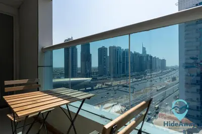 a table and chairs on a balcony with a view of a city at 1BR Cozy and Bright Dubai Marina in Dubai