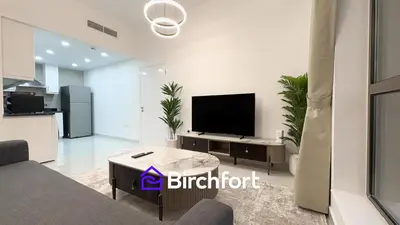 a living room with a flat screen tv on a wall at Spacious and Bright Retreat in JBR in Dubai
