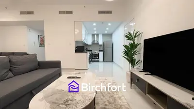 a living room with a couch and a flat screen tv at Spacious and Bright Retreat in JBR in Dubai