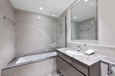 a bathroom with a sink and a shower and a mirror at VayK - Luxury 1BR in Downtown in Dubai