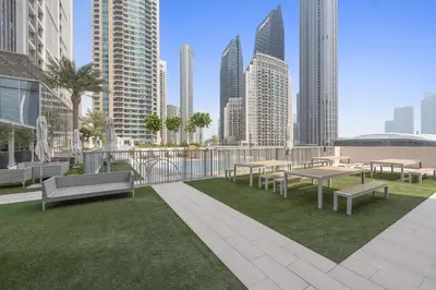 a balcony with tables and benches in a city at VayK - Luxury 1BR in Downtown in Dubai