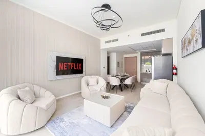 a living room with two white couches and a table at VayK - Modern 3BR with a Spacious Terrace in Dubai