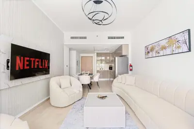 a white living room with a couch and a table at VayK - Modern 3BR with a Spacious Terrace in Dubai