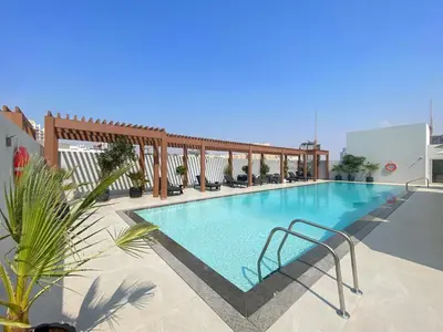 a swimming pool on the roof of a building at VayK - Stylish & Cozy Studio in JVC in Dubai
